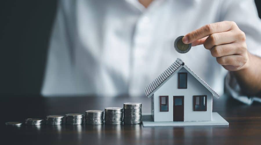 model house with coins to represent property investment